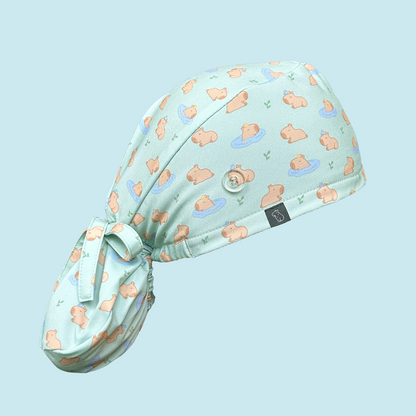 Light green scrub cap featuring capybaras