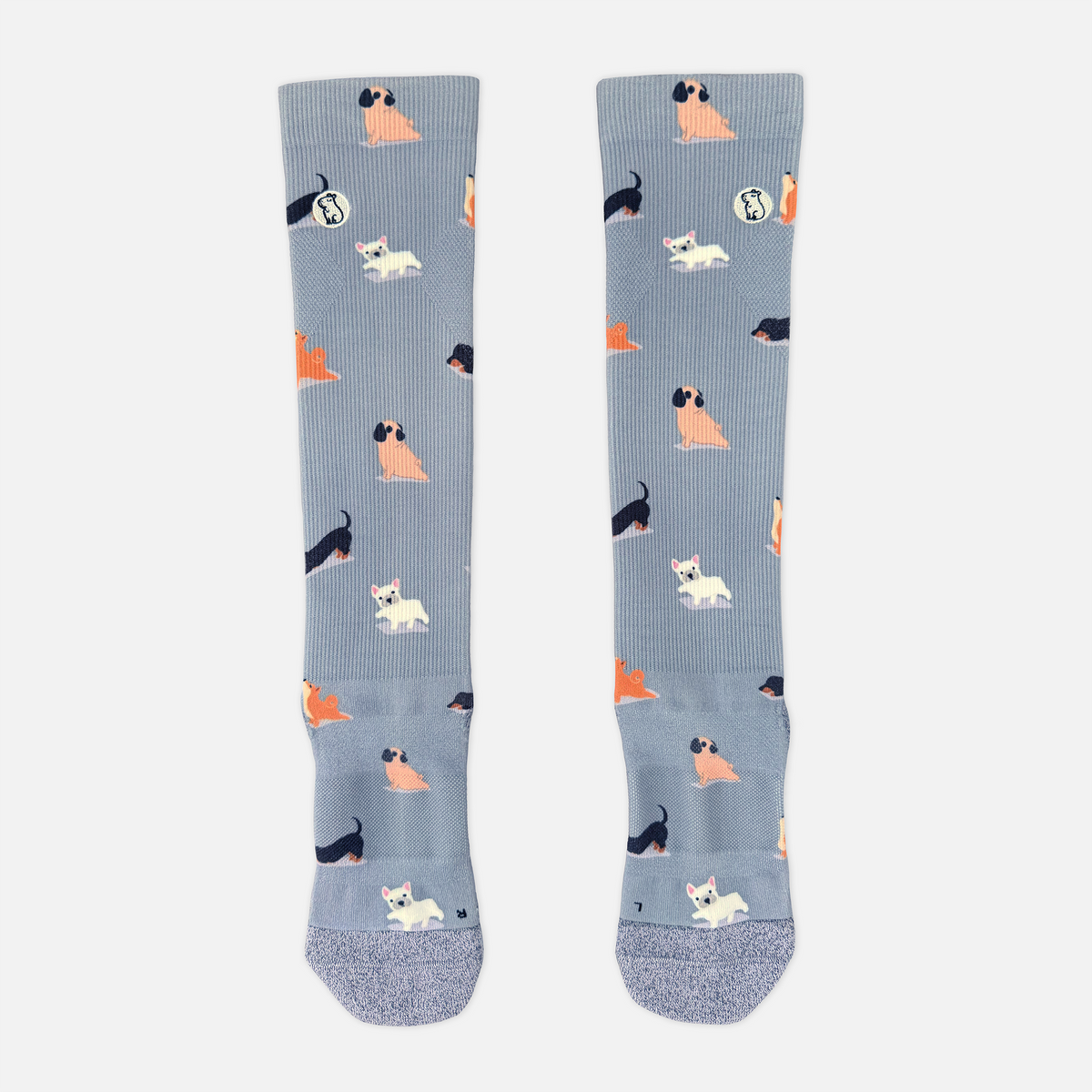 blue/purple compression sock with print featuring various dogs on light grey background