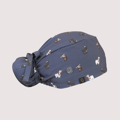 Side view of navy blue Bun scrub cap with various goats