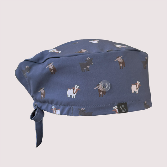 Side view of navy classic scrub cap with various goats