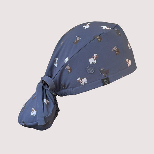 Side view of navy ponytail scrub cap with various goats