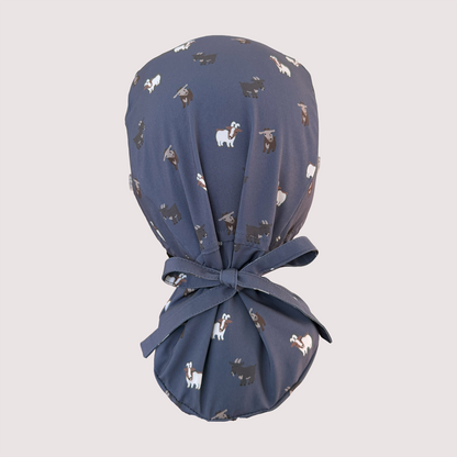 Rear view of navy ponytail scrub cap with various goats