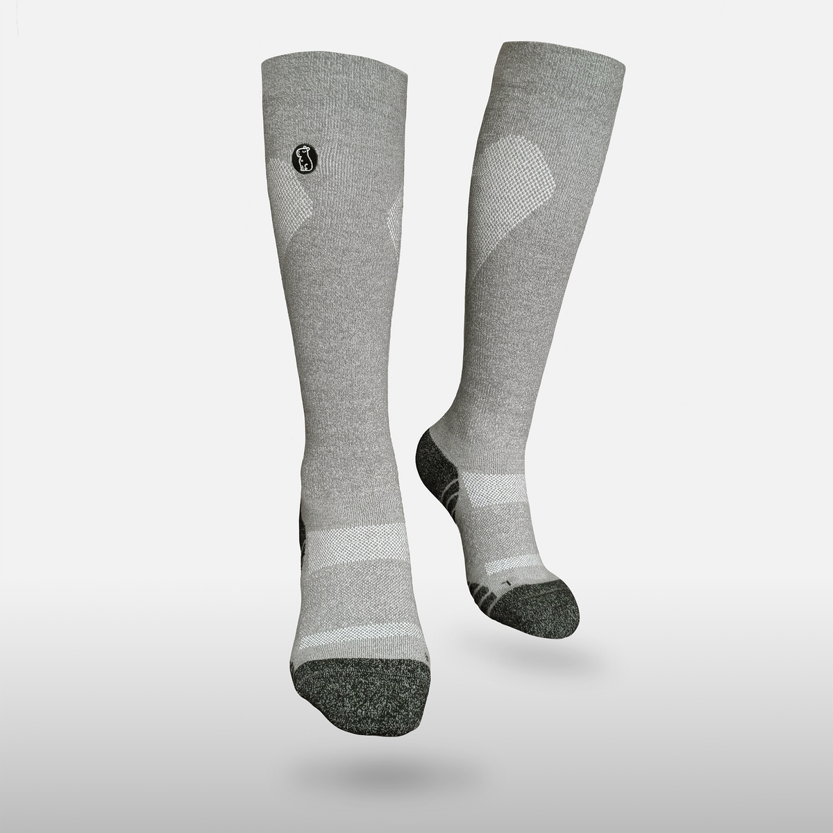 Floating heather grey compression sock with black toe and heel on light grey background