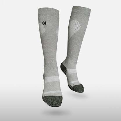 Floating heather grey compression sock with black toe and heel on light grey background