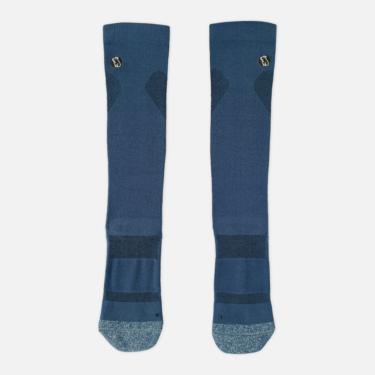 navy blue compression sock with light blue toe and heel on light grey background